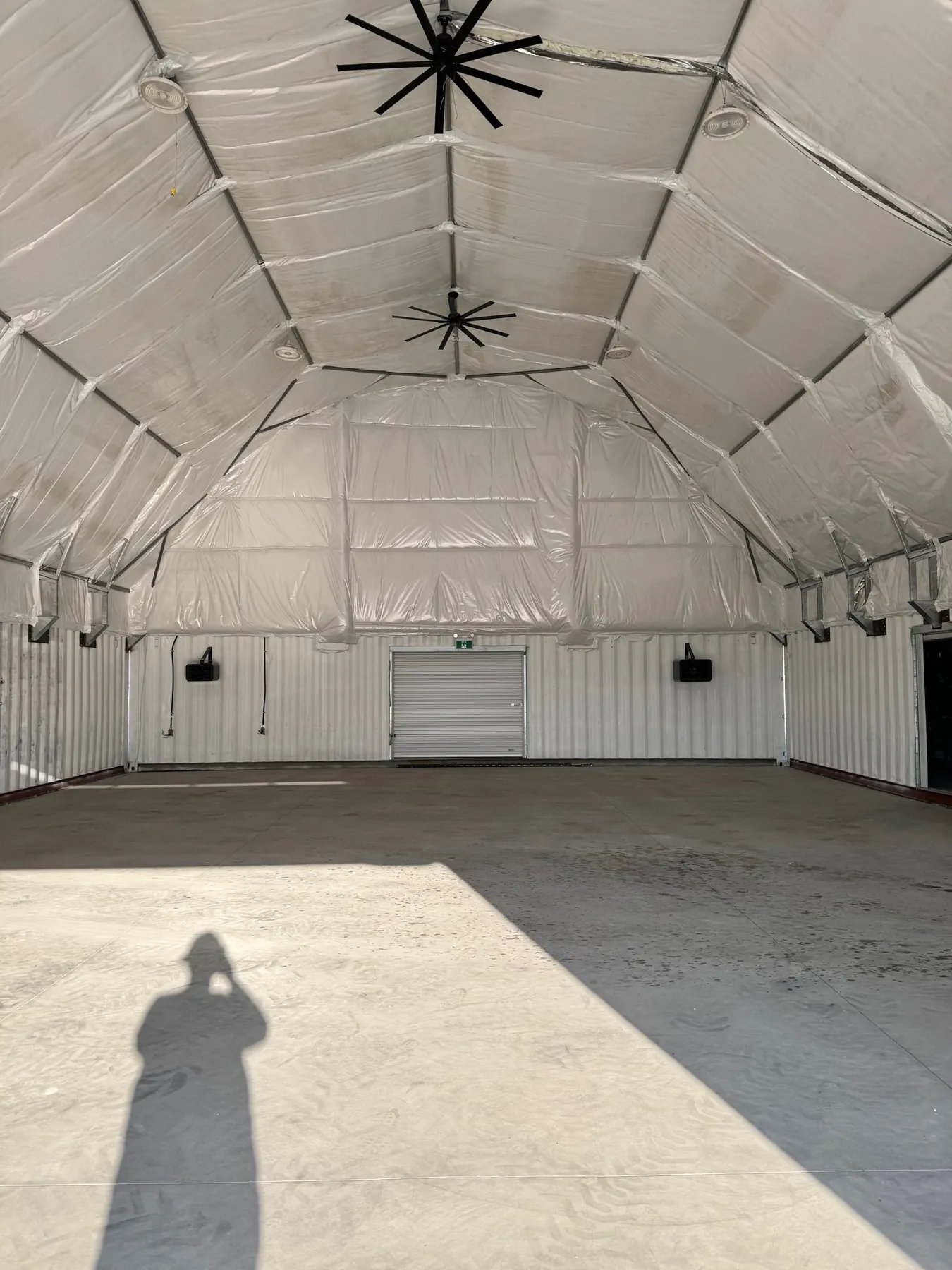 Insulated liner, ceiling fans and unit heaters inside a 50 by 100 foot fabric building in Princeton, BC