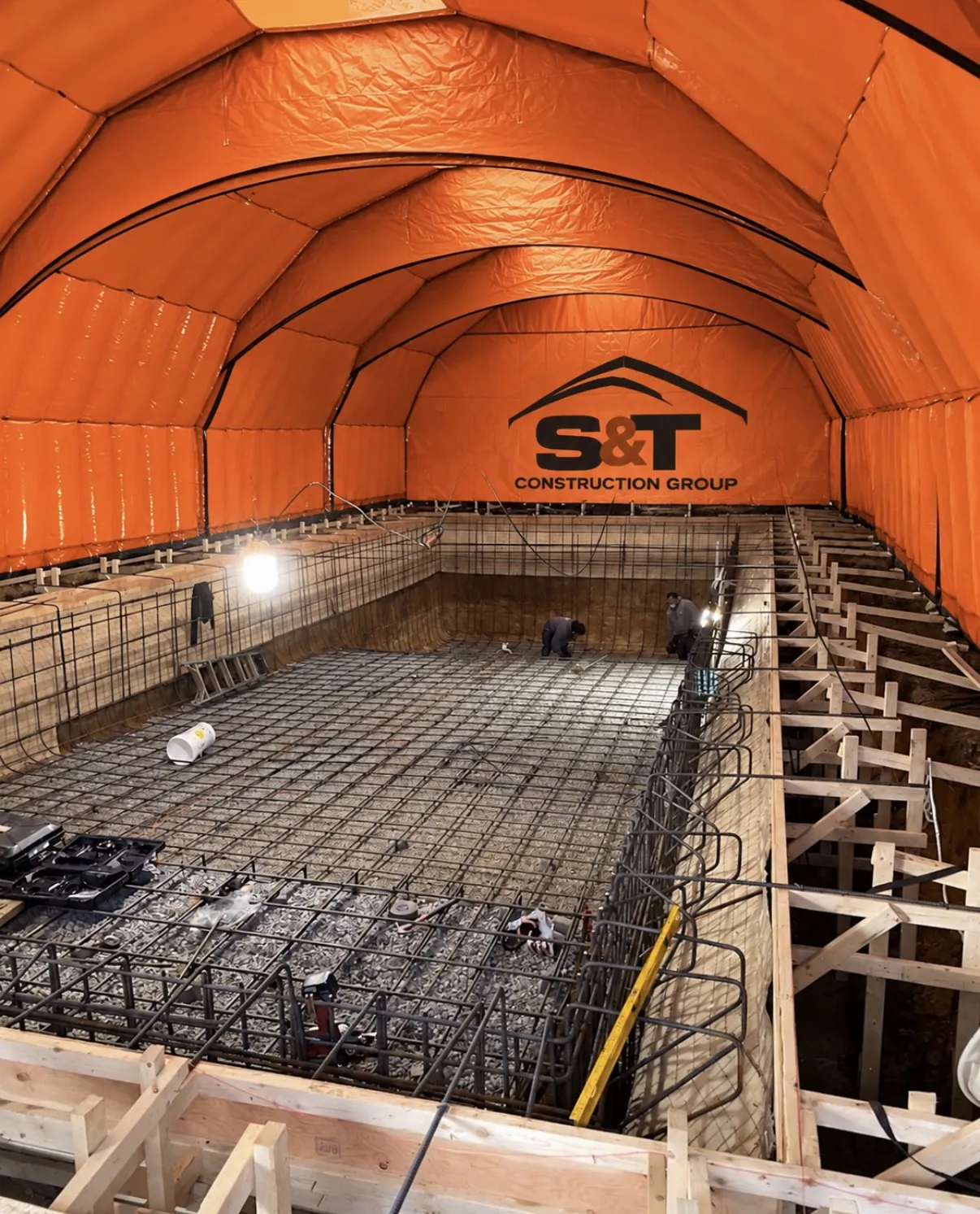 Orange 50 by 100 foot S&T air dome enclosing a construction site in Calgary